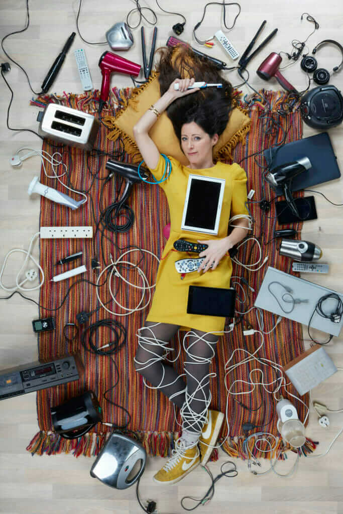 overhead shot of Natalie Fee surrounded by household electricals photo by Gregg Segal